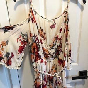 Floral romper with peek-a-boo shoulder